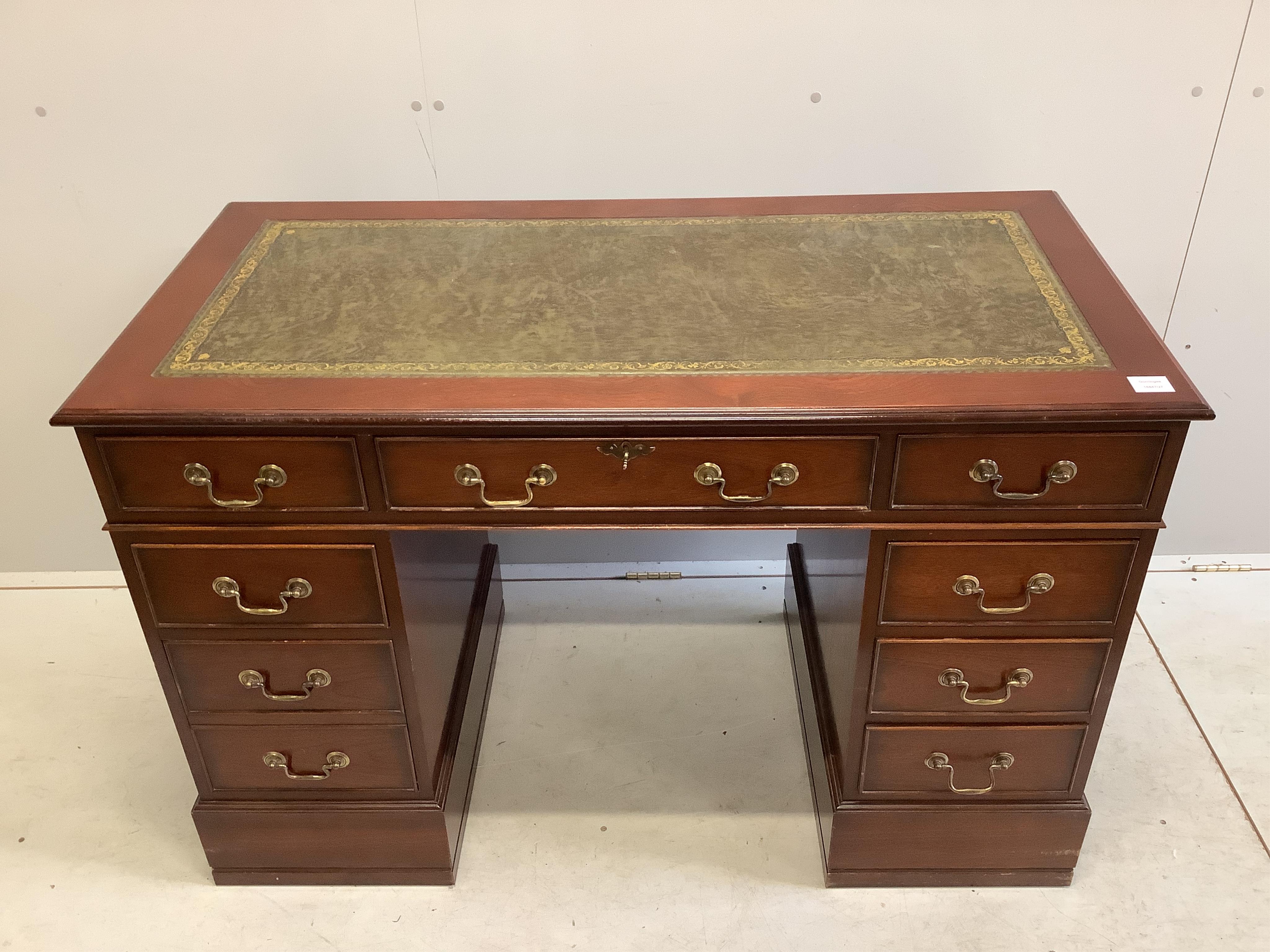 A George III style mahogany pedestal desk, fitted with nine small drawers, width 121cm, depth 60cm, height 79cm. Condition - fair to good